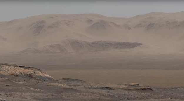 An astronaut standing on the surface of Mars